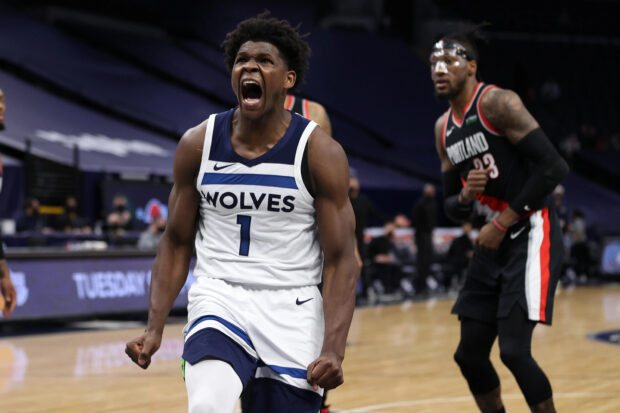 Anthony Edwards celebrates intensely during a Wolves basketball game in action