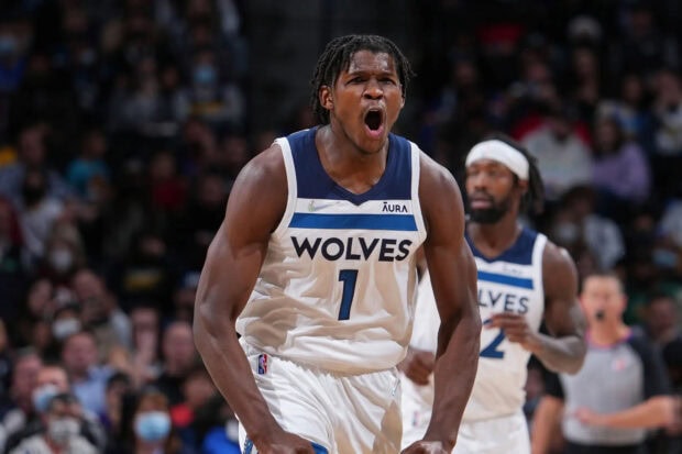 Anthony Edwards showing intense emotion during a basketball game in Wolves uniform
