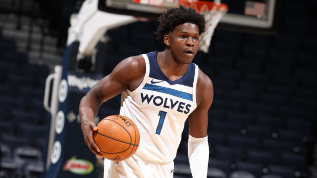Anthony Edwards dribbling a basketball during a game for the Wolves in a white jersey