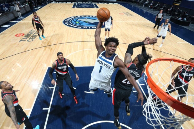 Anthony Edwards jumping to score a basket during a Minnesota Timberwolves basketball game