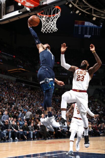 Anthony Edwards jumping to score during a basketball game against Cleveland Cavaliers defender LeBron James