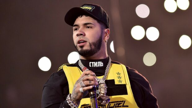 Anuel Aa is performing live with a microphone in his hand during a concert, HD Desktop Wallpaper