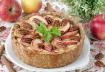 A pie with apple slices and pecans garnished with fresh mint leaves on a floral tablecloth, HD Desktop Wallpaper