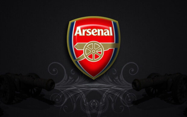 The Arsenal logo with two cannons and decorative swirls on a dark background