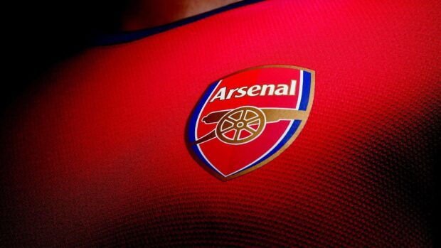 Close up of Arsenal Fc logo on a red football jersey fabric
