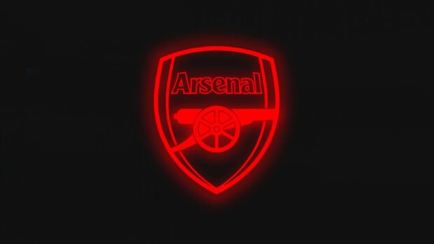 Neon red glowing Arsenal Fc emblem on a black background