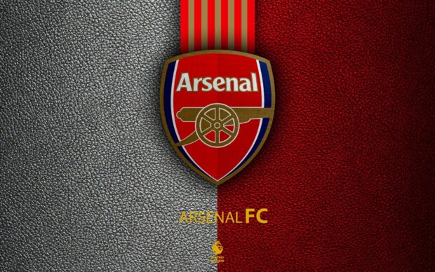 Arsenal fc crest on leather textured background representing Arsenal fc