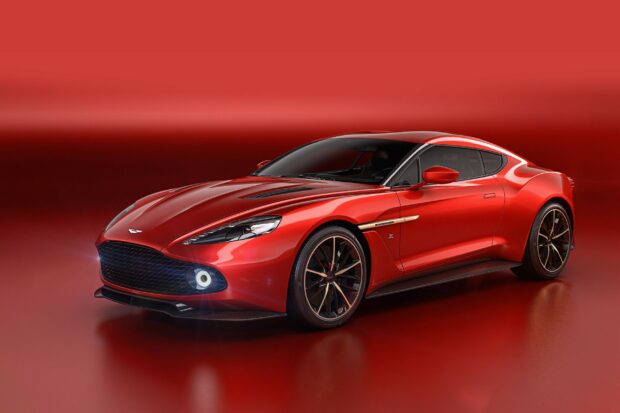 A red Aston Martin car with sleek design and black roof on a red background