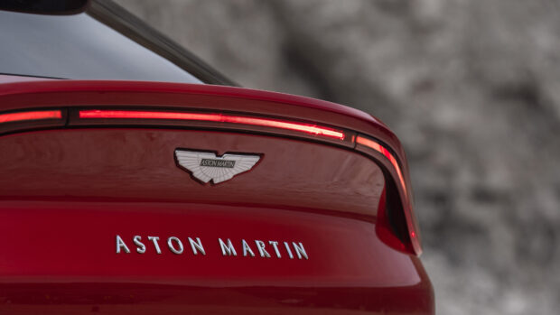 Close up of Aston Martin emblem on the rear of a red car