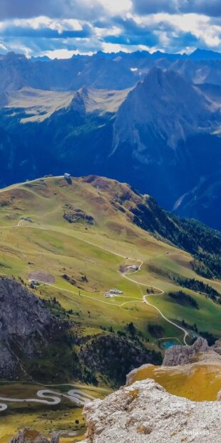 The Austria Wallpapers capture a scenic mountain valley with winding roads and rocky peaks, HD Phone Wallpaper