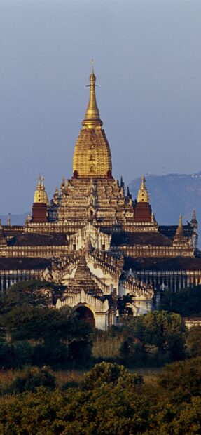 Ancient Bagan temple surrounded by lush greenery in Myanmar landscape
