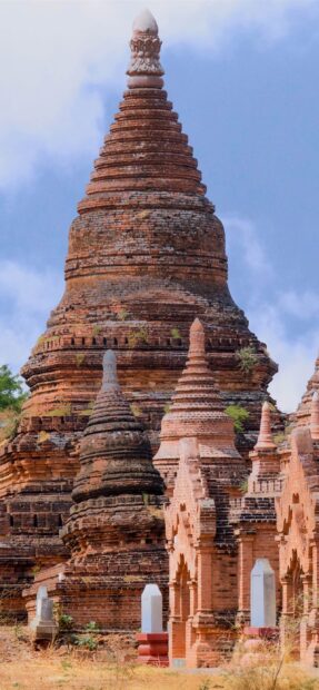 Ancient brick stupas in Bagan with detailed architecture under a clear sky