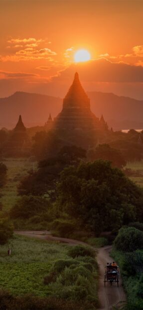A serene view of Bagan temples with a sunset over the ancient cityscape in Myanmar