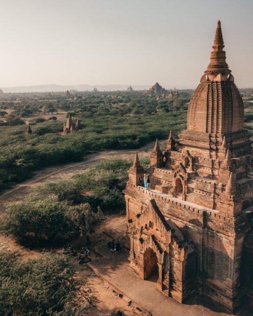 Ancient Bagan temple surrounded by greenery in Myanmar landscape with Bagan architecture