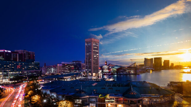 The Baltimore city skyline at dusk with vivid lights and colorful sky
