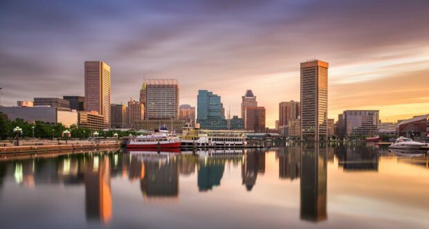 A stunning view of Baltimore skyline at sunset with reflections in the water