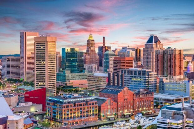 Baltimore skyline at sunset with colorful clouds and illuminated buildings in HD quality