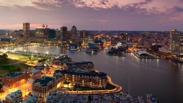 Baltimore skyline view at dusk with city lights reflecting on the water