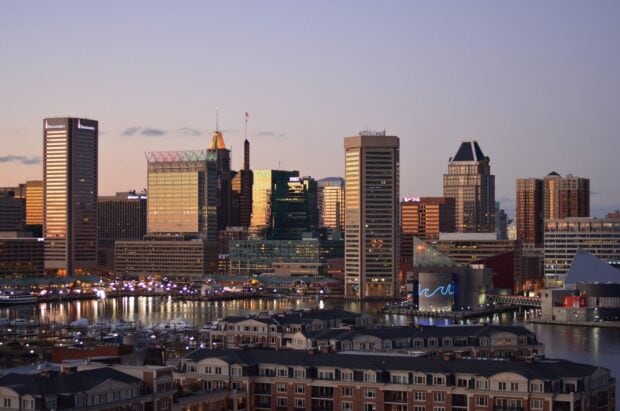 Baltimore skyline with modern buildings reflecting sunset light over the harbor