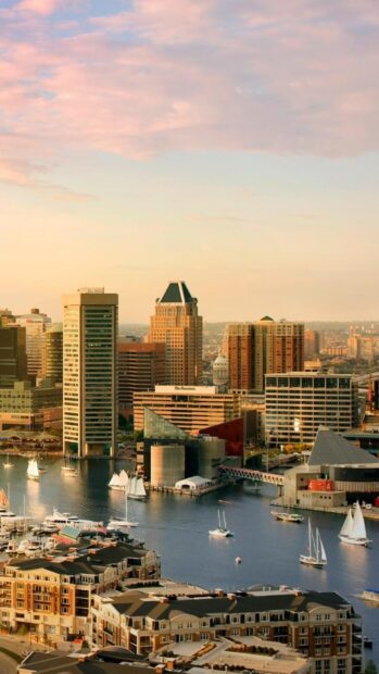 Baltimore skyline with boats and high rise buildings at sunset in HD quality
