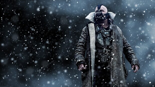 Bane character from Batman stands in a snowy environment wearing a heavy coat and mask