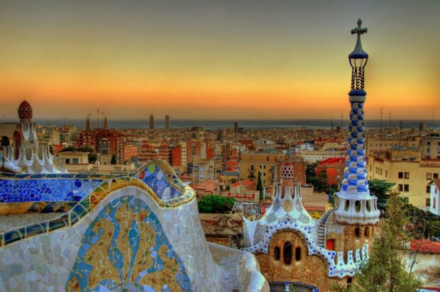 The Barcelona cityscape features colorful mosaic architecture and a sunset sky, HD Desktop Wallpaper