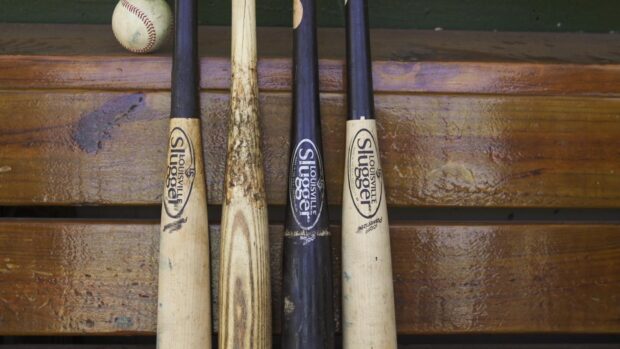 Four baseball bats resting on a bench with a baseball above them ready for play, HD Desktop Wallpaper