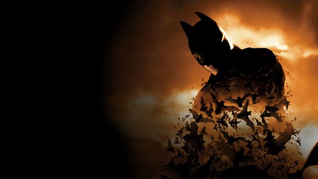 Batman Begins character surrounded by flying bats in a dark smoky background