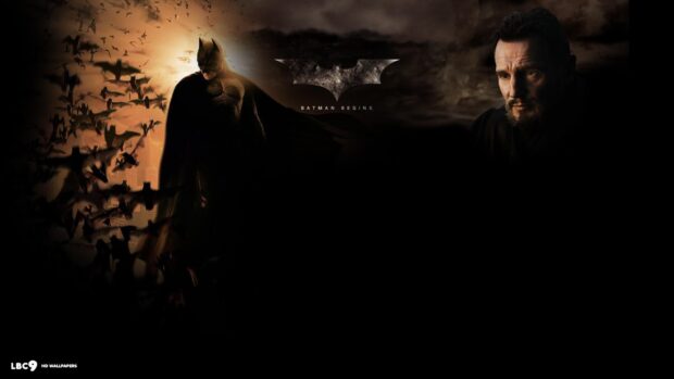 Batman Begins character standing with bats flying around him in a dark cityscape at sunset