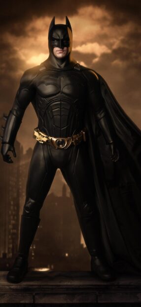The Batman Begins character standing on rooftop in a dark cityscape at night
