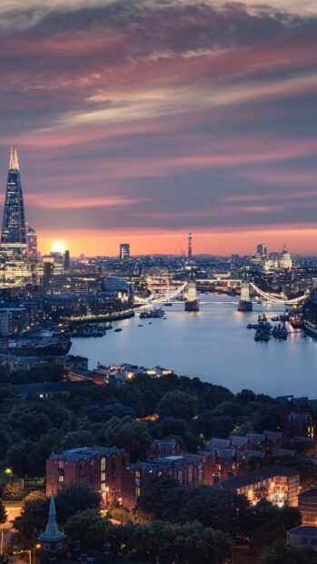 The London skyline features iconic landmarks along the Thames River under a colorful sunset sky, 4K Phone Wallpaper