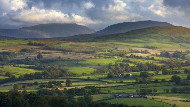 A scenic view of green rolling hills under a cloudy sky in the United Kingdom, HD Desktop Wallpaper
