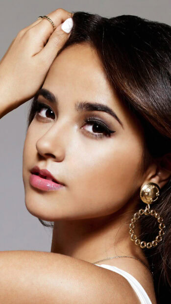 Becky G close up showing detailed makeup and large gold earrings