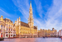 The Grand Place square with historic buildings in Belgium under a clear blue sky