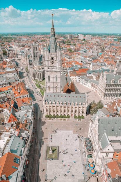 Historic Belgium cityscape with medieval towers and red rooftops in HD quality background
