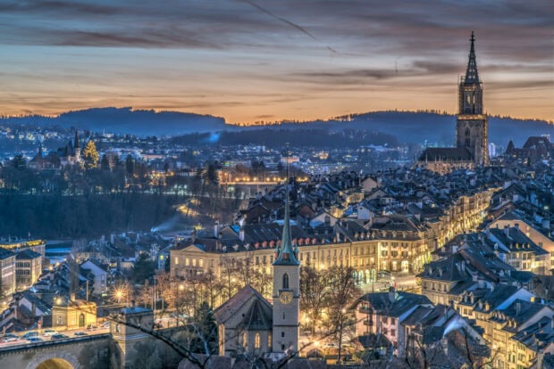 Bern Switzerland Wallpaper HD Desktop A panoramic view of Bern Switzerland at dusk with illuminated historic buildings and churches