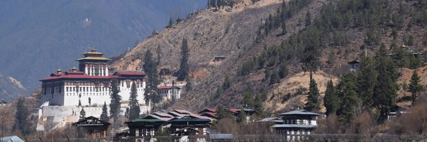 Traditional Bhutan architecture nestled in the scenic Bhutan mountains with clear skies