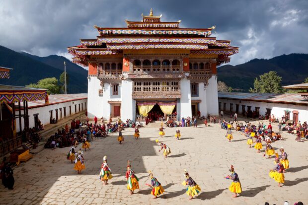 Traditional Bhutan cultural festival taking place in front of an ornate historic building