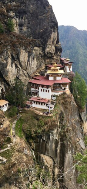 Ancient Bhutan cliffside monastery nestled on rocky mountain terrain