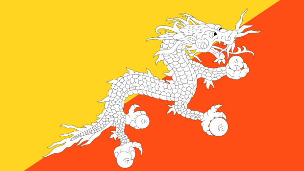 White dragon symbol on the Bhutan flag with yellow and orange background