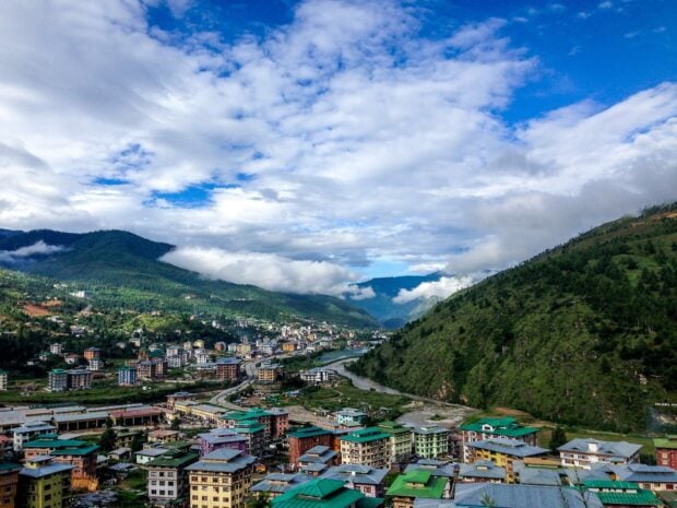 A beautiful town landscape of Bhutan surrounded by green hills and cloudy sky