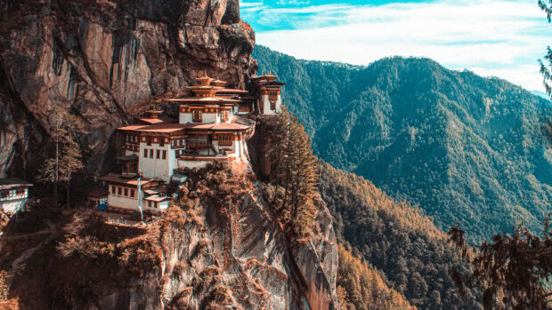Tiger Nest Monastery nestled on a cliff surrounded by lush mountains in Bhutan