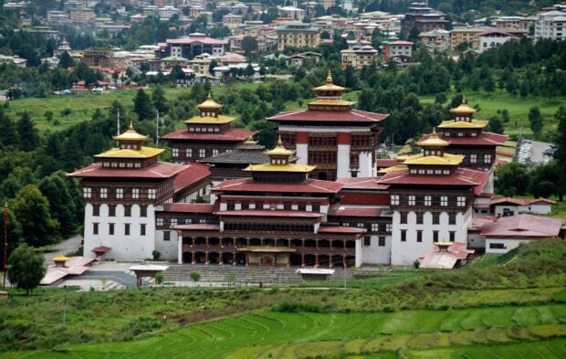 Traditional Bhutan architecture surrounded by lush green landscapes in Bhutan