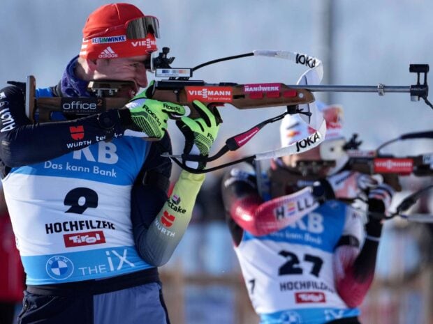 Biathlon athlete aiming with rifle during competition in high quality HD