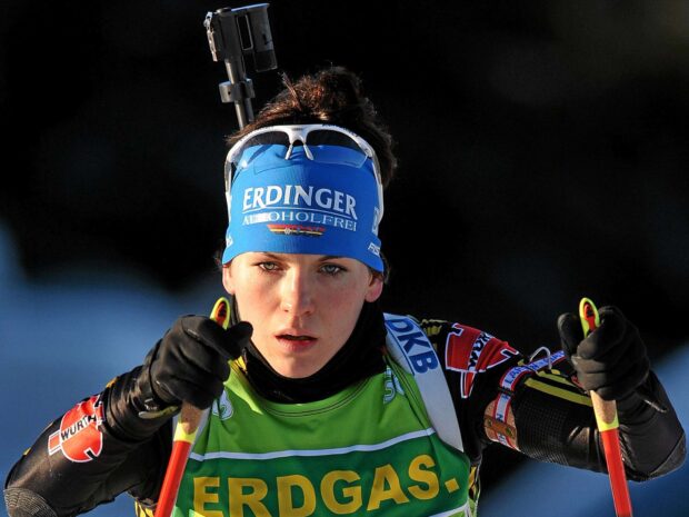 Female biathlon athlete focused during competition in winter sports event