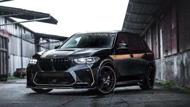Black BMW X5 with custom gold accents parked in industrial area, 4K Desktop Wallpaper