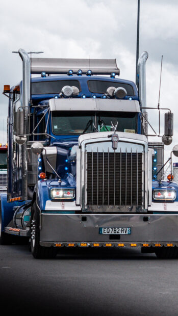 A blue Kenworth truck with chrome details is parked under cloudy sky, HD Phone Wallpaper