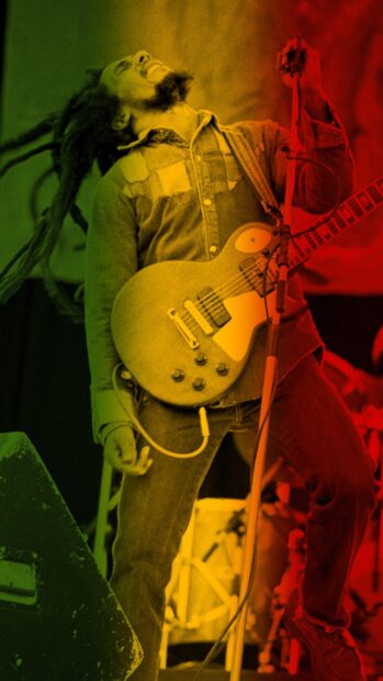 Bob Marley Wallpapers showing a passionate musician playing guitar on stage, 2K Phone Wallpaper