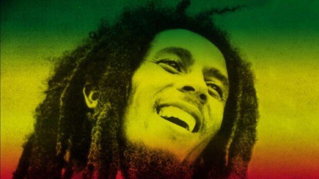 A close up of Bob Marley smiling with green yellow and red colors in the background, HD Desktop Wallpaper