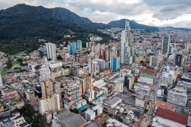 A beautiful view of Bogota city with tall buildings and mountains in the background, HD Desktop Wallpaper